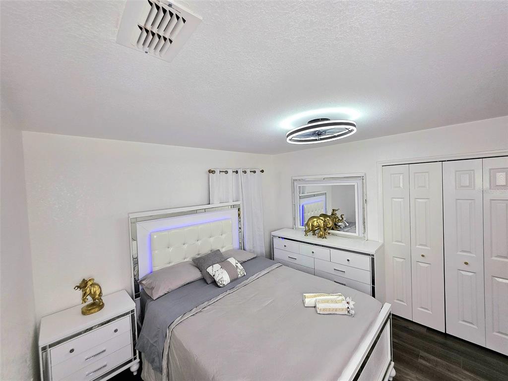 24921 Ravello Street Land O Lakes, FL 34639 - Photo 2 of 36 a bedroom with a bed and a dresser