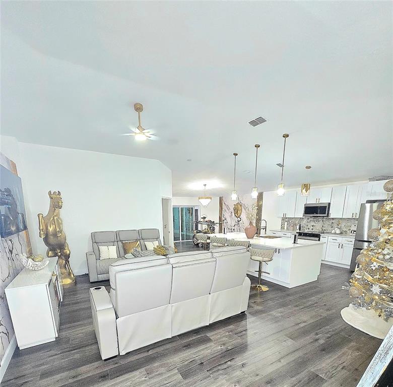 24921 Ravello Street Land O Lakes, FL 34639 - Photo 21 of 36 a living room with lots of furniture and kitchen view