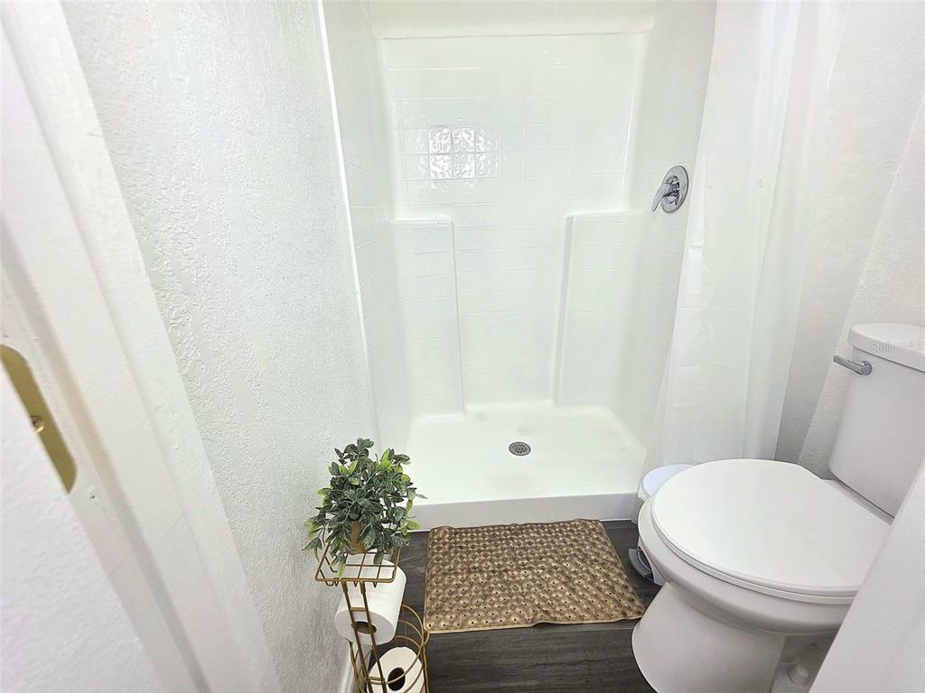 24921 Ravello Street Land O Lakes, FL 34639 - Photo 23 of 36 a bathroom with a toilet and a shower