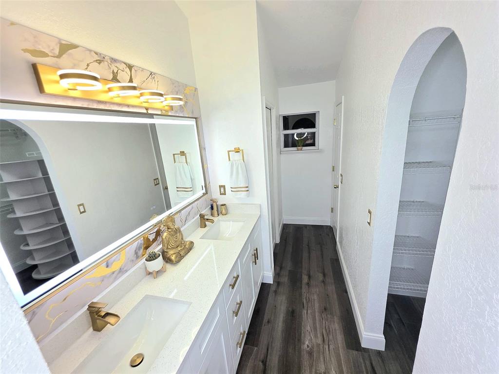 24921 Ravello Street Land O Lakes, FL 34639 - Photo 26 of 36 a spacious bathroom with a sink and mirror