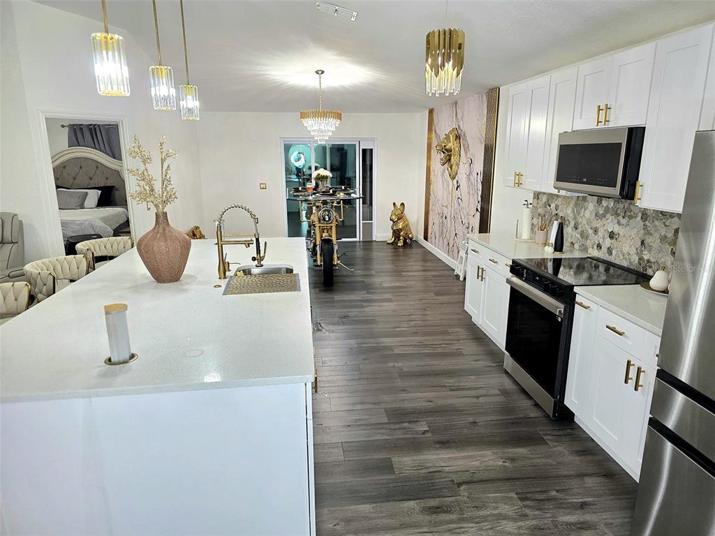 24921 Ravello Street Land O Lakes, FL 34639 - Photo 30 of 36 a kitchen with granite countertop a sink and a stove top oven