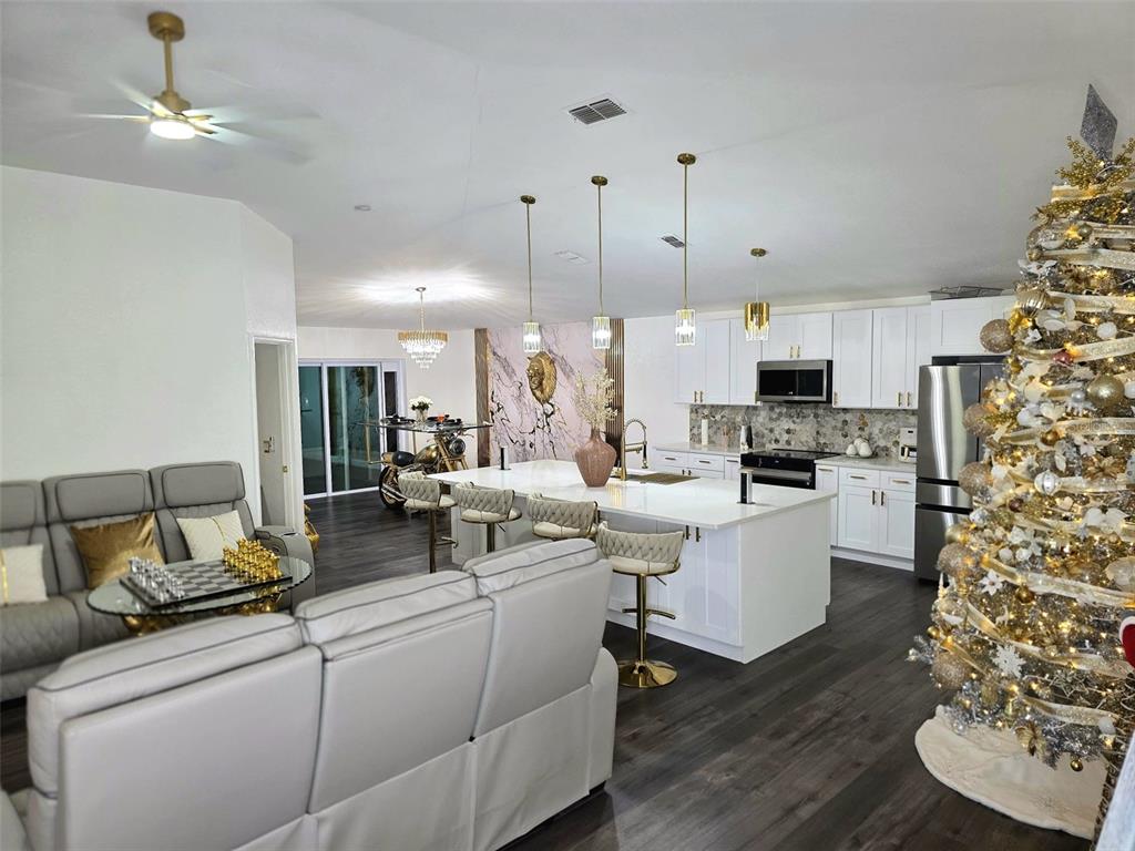 24921 Ravello Street Land O Lakes, FL 34639 - Photo 35 of 36 a living room with fireplace furniture and a chandelier