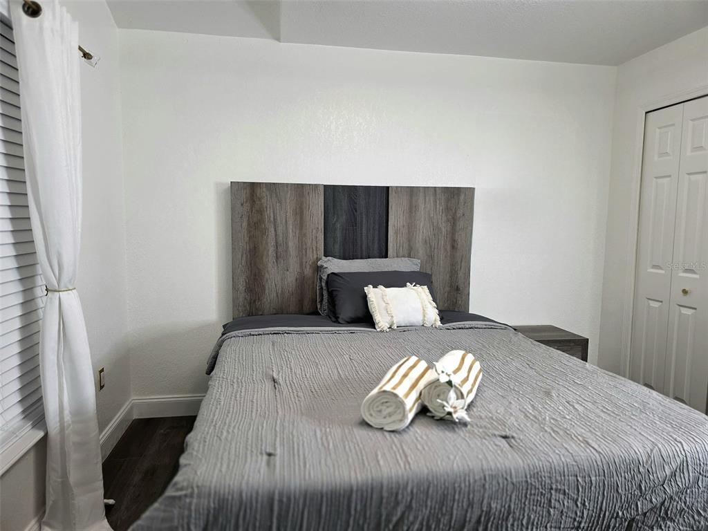 24921 Ravello Street Land O Lakes, FL 34639 - Photo 4 of 36 a bedroom with a bed and wooden floor