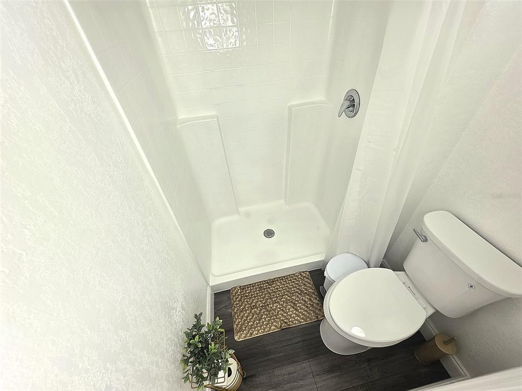 24921 Ravello Street Land O Lakes, FL 34639 - Photo 7 of 36 a bathroom with a toilet and a shower