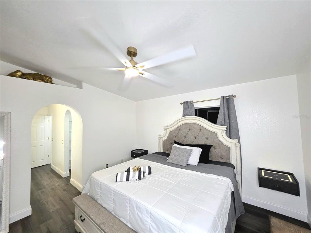 24921 Ravello Street Land O Lakes, FL 34639 - Photo 8 of 36 a bedroom with a bed and a chandelier