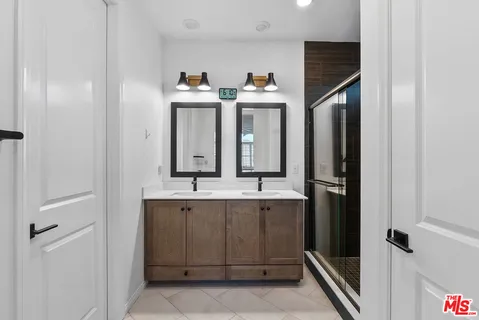 a bathroom with a double vanity sink and mirror