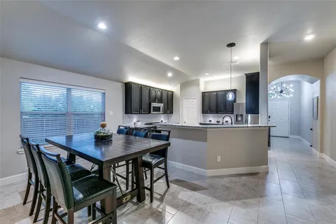a view of a dining room with furniture and a flat screen tv