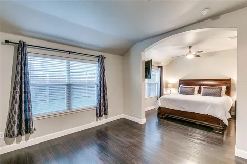 a bedroom with a bed and a large window