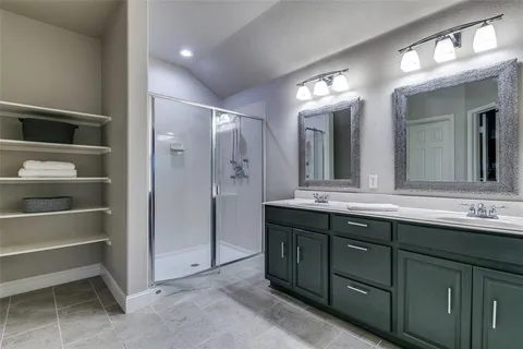 a bathroom with a double vanity sink and a mirror