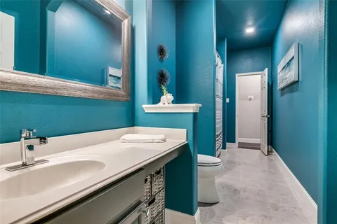 a bathroom with a sink a toilet and mirror