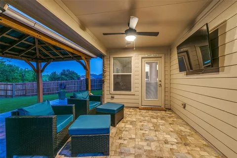 a view of a porch with furniture and a yard