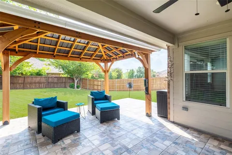 a view of swimming pool with a couches in a patio