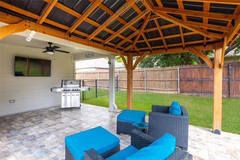 a view of a backyard with couches plants and swimming pool