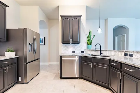 a kitchen with a sink and stainless steel appliances