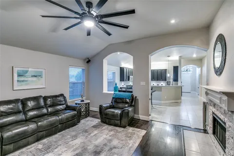 a living room with furniture and a fireplace