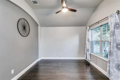 a view of a room with wooden floor and window