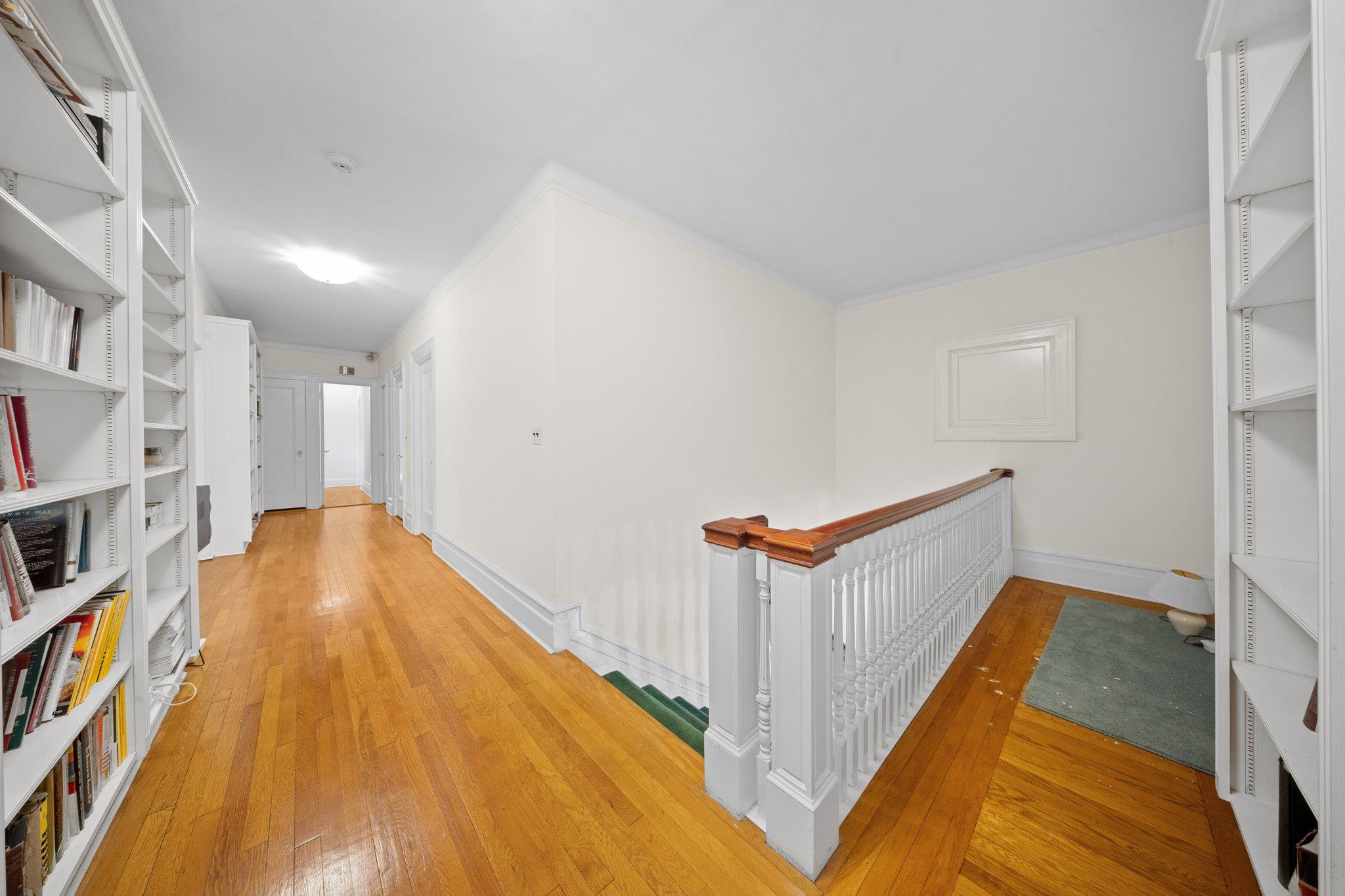 10-08 Shore Road Queens, NY 11363 - Photo 19 of 47 a bed room with a bed and a book shelf