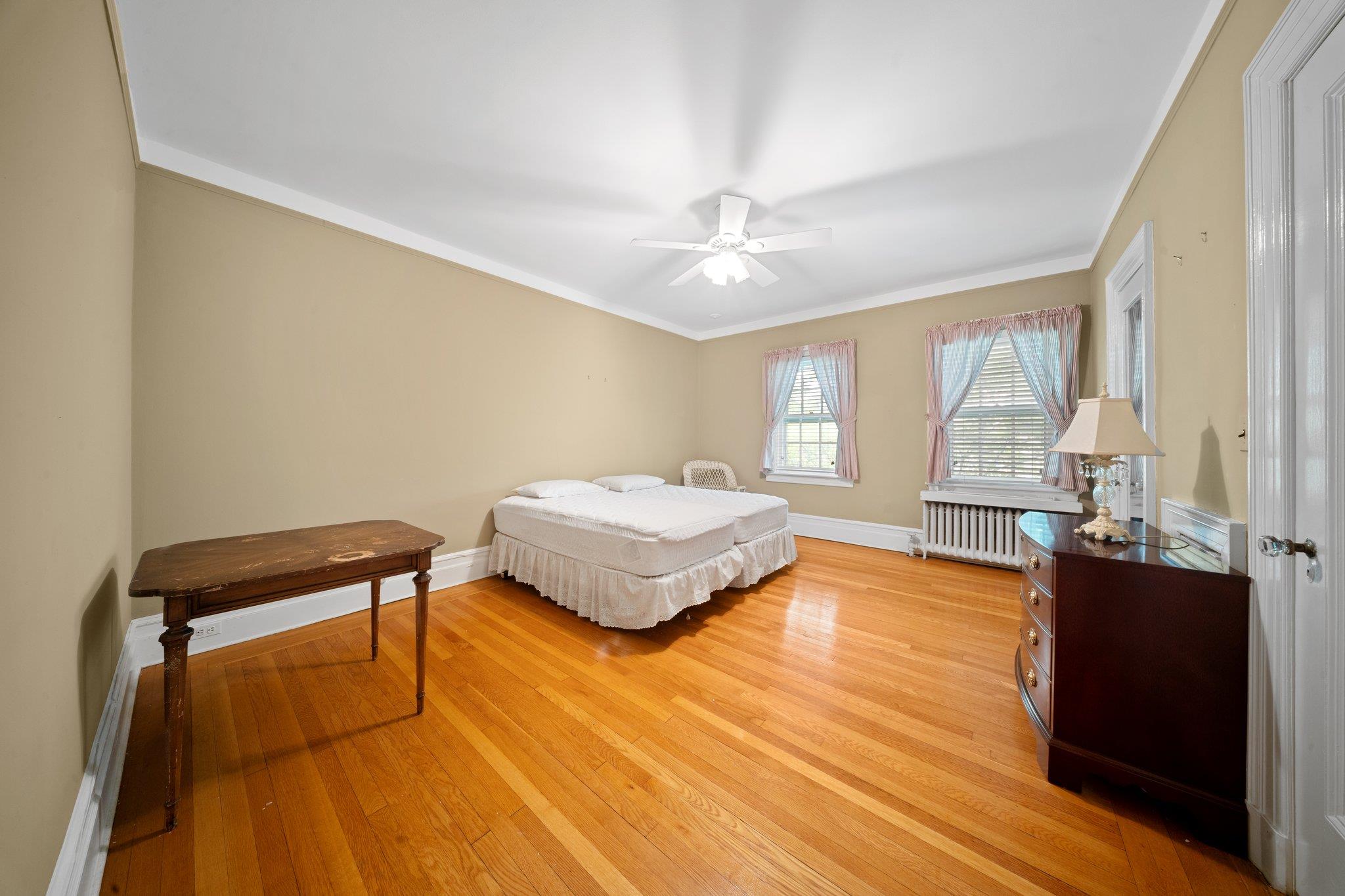 10-08 Shore Road Queens, NY 11363 - Photo 27 of 47 a spacious bedroom with a bed and wooden floor