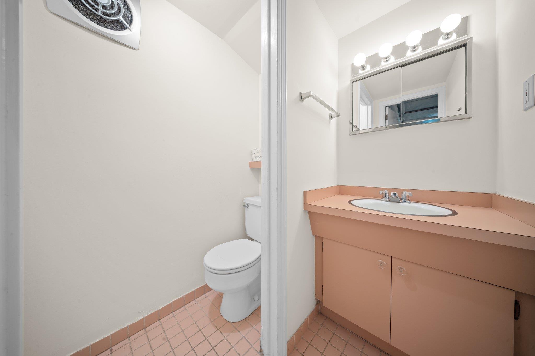 10-08 Shore Road Queens, NY 11363 - Photo 32 of 47 a bathroom with a sink a toilet and mirror