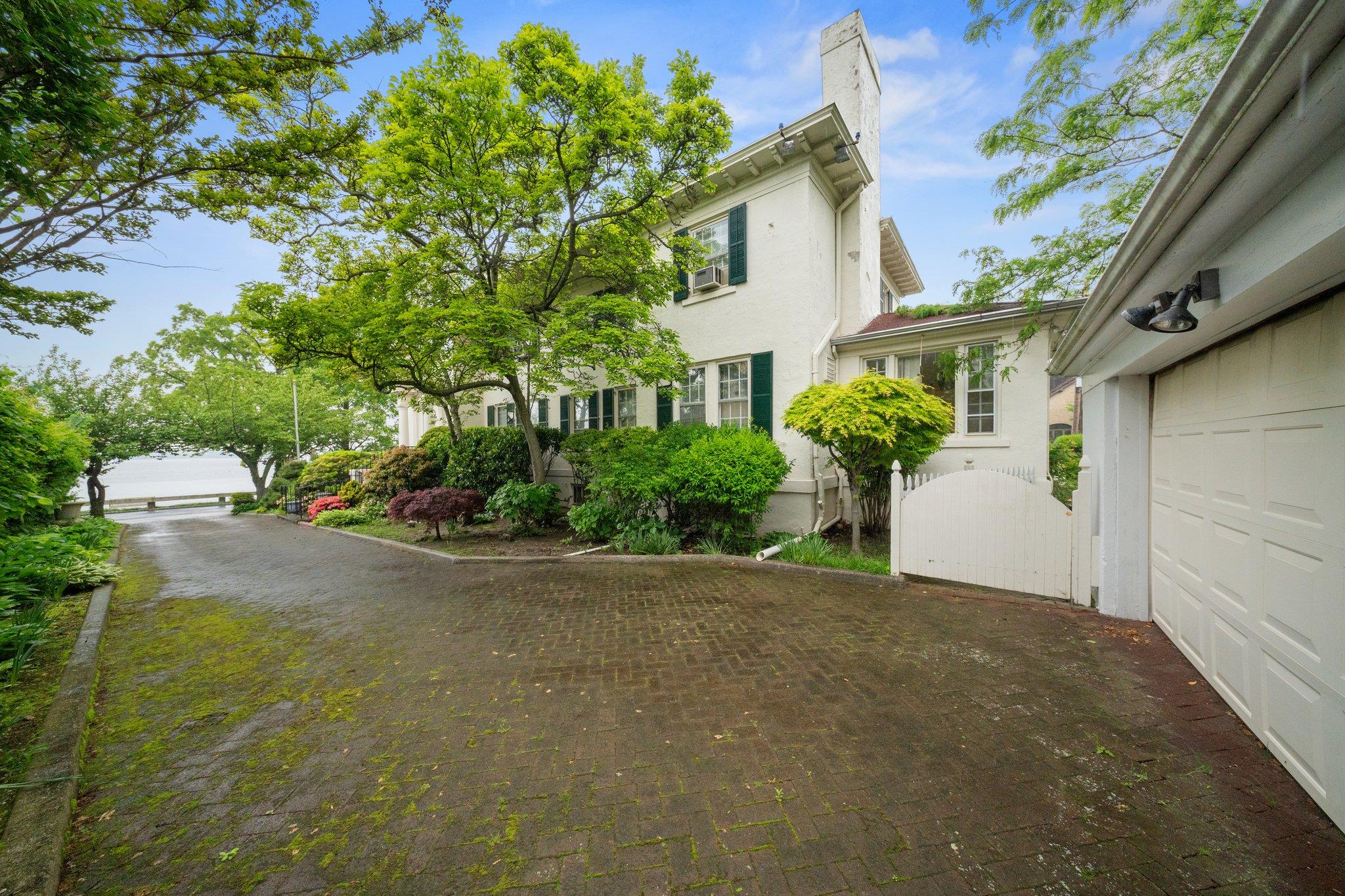 10-08 Shore Road Queens, NY 11363 - Photo 37 of 47 a front view of a house with garden