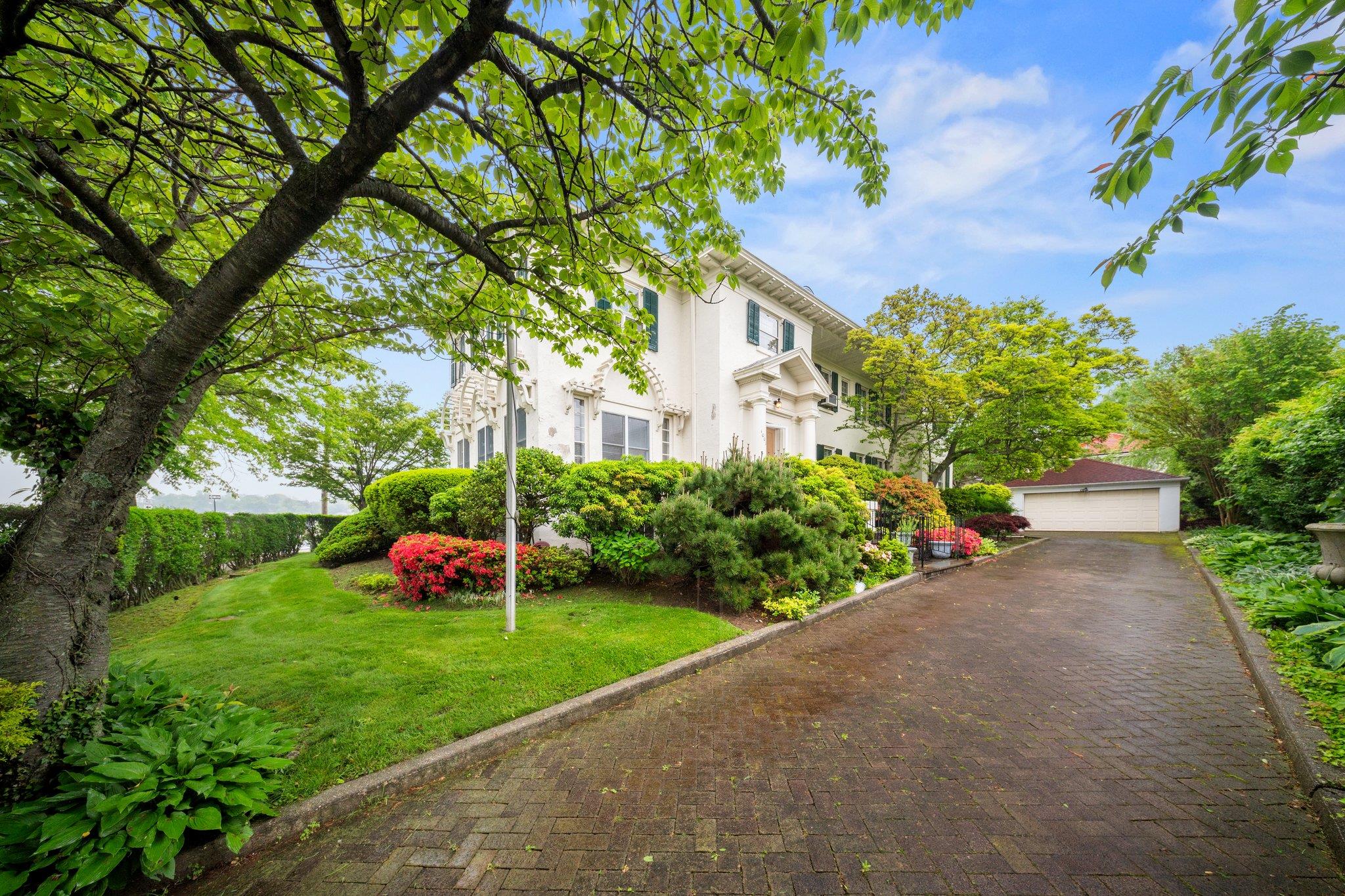 10-08 Shore Road Queens, NY 11363 - Photo 4 of 47 a view of a garden with plants and large trees