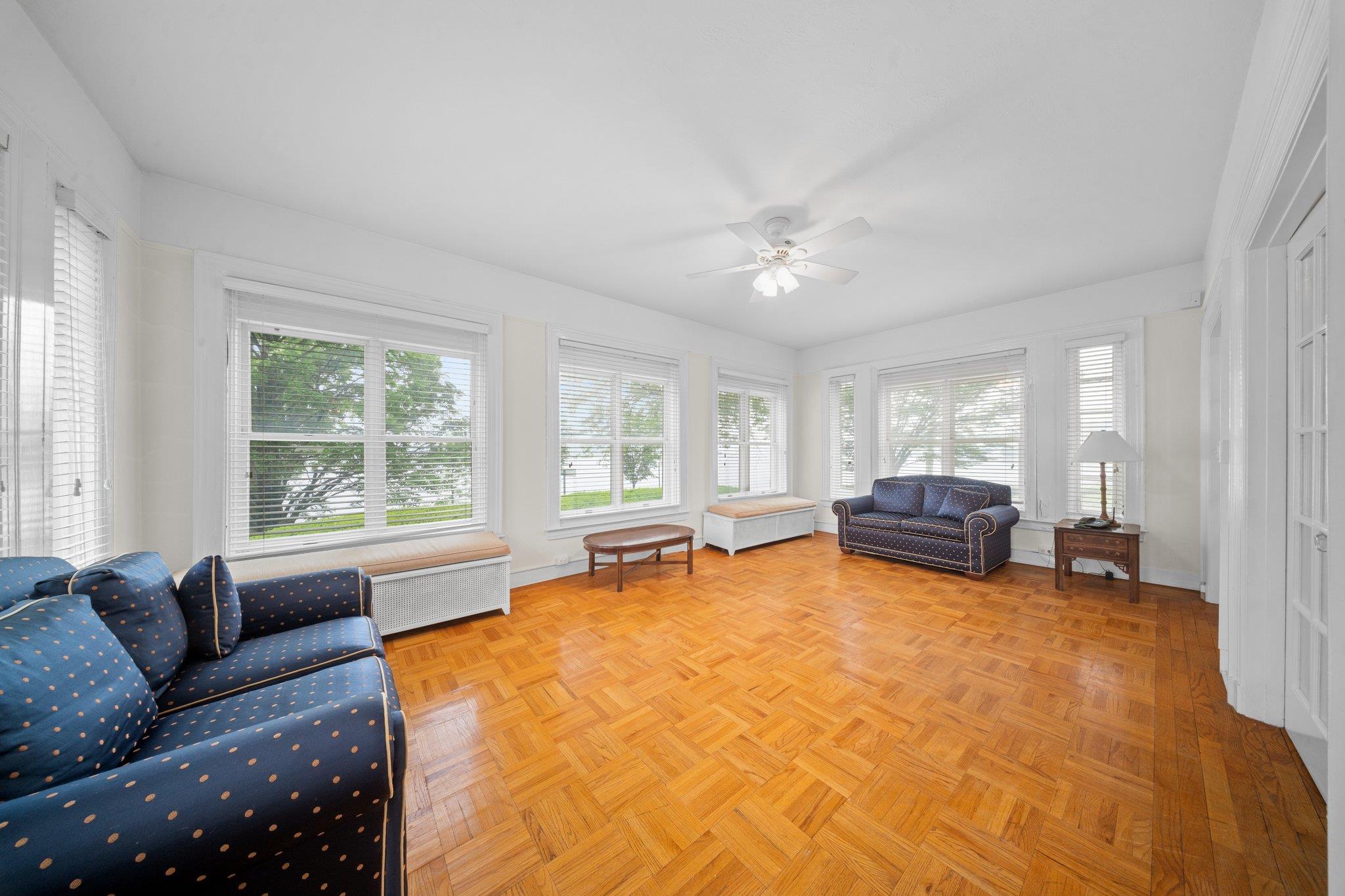 10-08 Shore Road Queens, NY 11363 - Photo 8 of 47 a living room with furniture and a large window with garden view