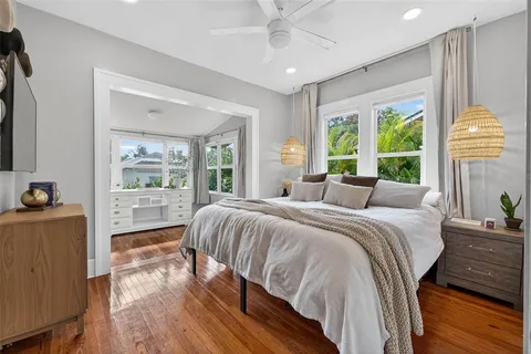 a bedroom with a bed and a large window