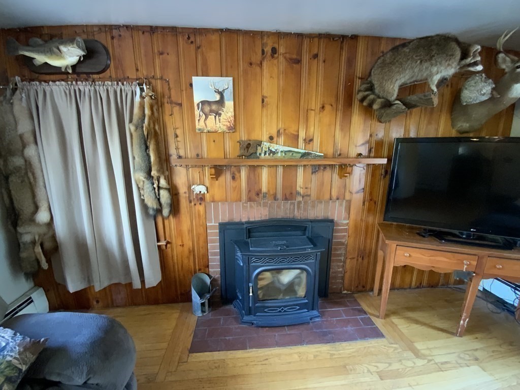 731 Greenfield Road Leyden, MA 01337 - Photo 11 of 36 a living room with furniture and a fireplace