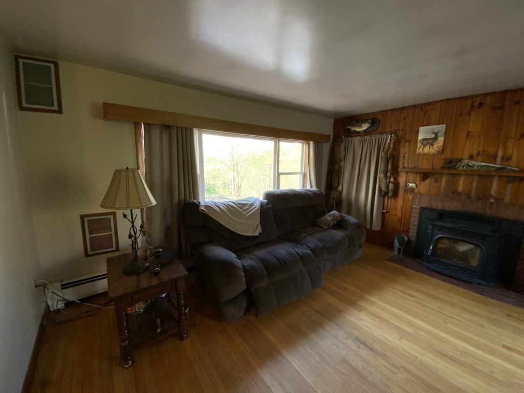 731 Greenfield Road Leyden, MA 01337 - Photo 12 of 36 a living room with furniture and a fireplace