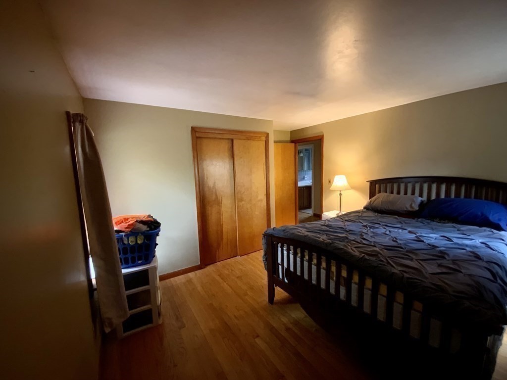 731 Greenfield Road Leyden, MA 01337 - Photo 22 of 36 a bedroom with a bed and wooden floor