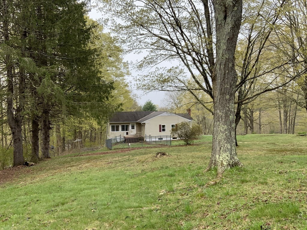 731 Greenfield Road Leyden, MA 01337 - Photo 3 of 36 a view of a yard with large trees and a barn