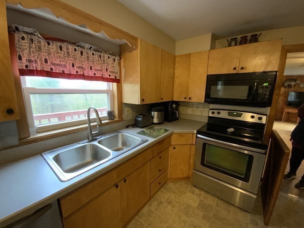 731 Greenfield Road Leyden, MA 01337 - Photo 7 of 36 a kitchen with a stove a sink and a microwave