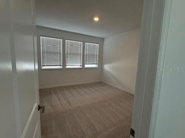 an empty room with a empty space and windows