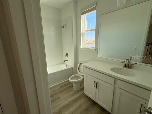 a bathroom with a shower sink and mirror