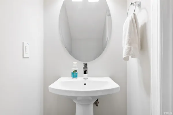 a bathroom with a sink a mirror and vanity