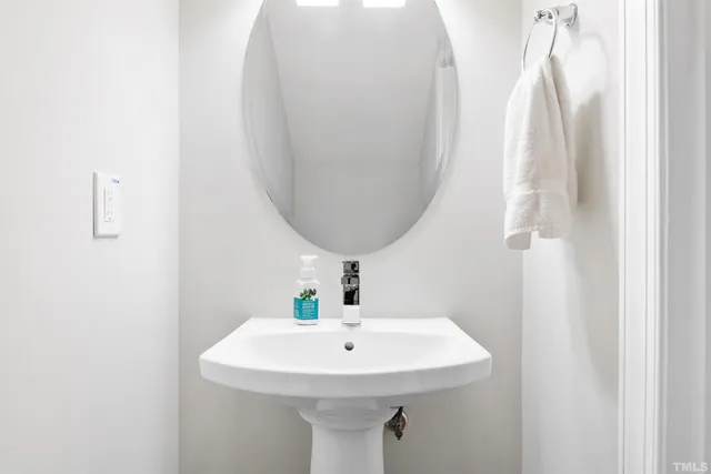 a bathroom with a sink a mirror and vanity