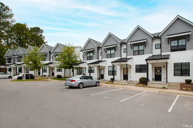a buildings with car parked in front of it