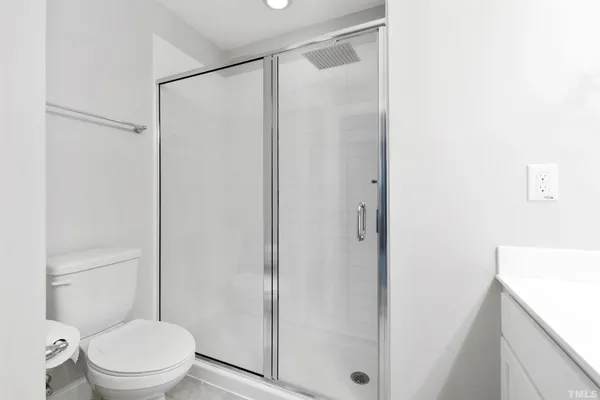 a white toilet sitting next to a bathroom sink