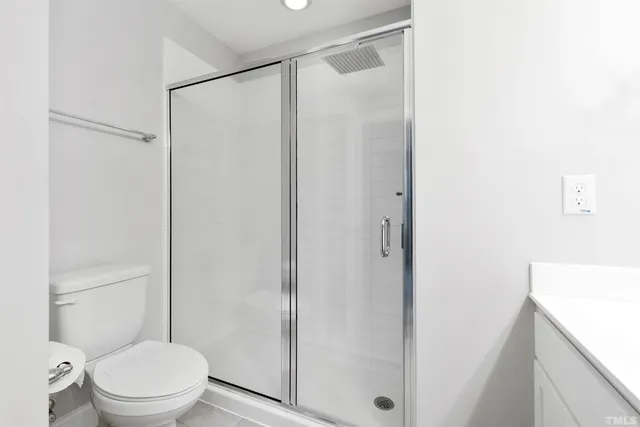 a white toilet sitting next to a bathroom sink