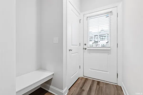 a view of a room with wooden floor and a window