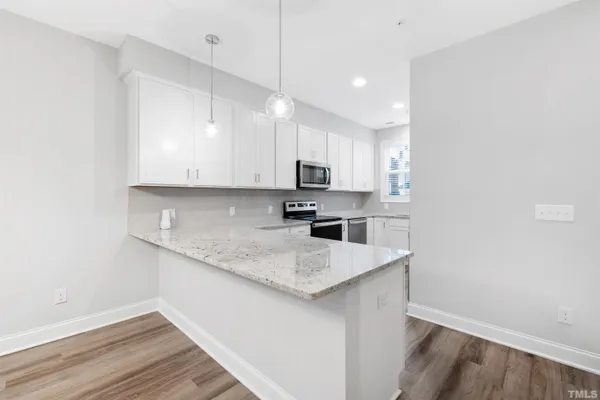 a kitchen with a sink a microwave and cabinets