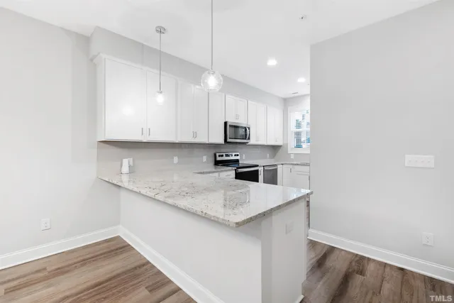 a kitchen with a sink a microwave and cabinets