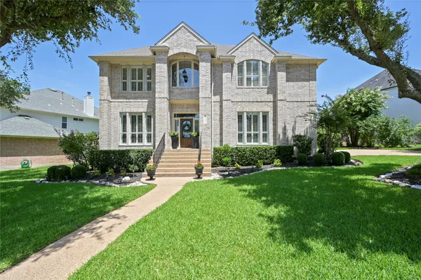 a front view of a house with a yard