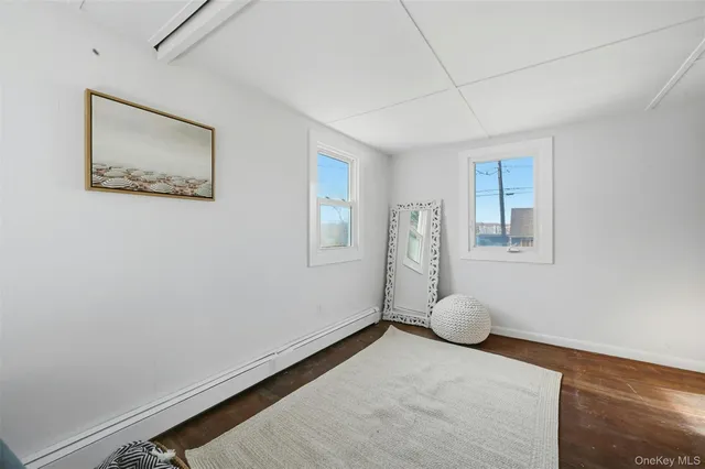 a view of a room with wooden floor and window