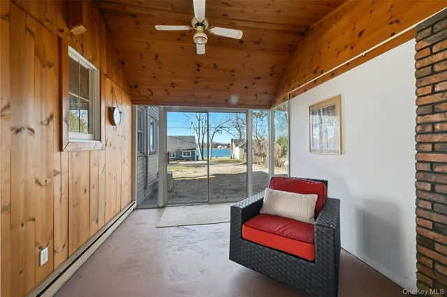 a view of a balcony with furniture and a potted plant