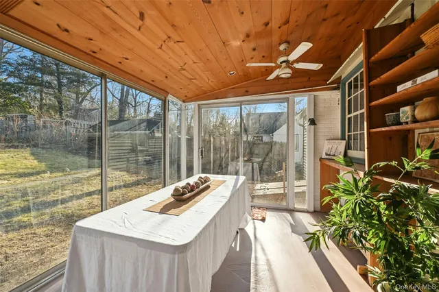 a room with patio furniture and a potted plant