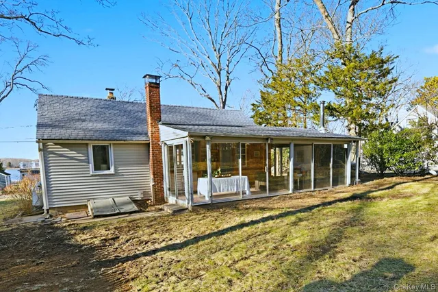 a view of a house with garden and sitting area
