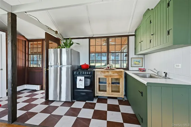 a kitchen with stainless steel appliances granite countertop a refrigerator and a sink