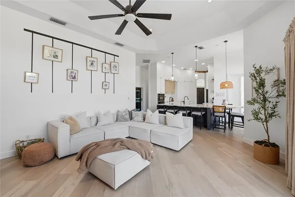 a living room with furniture and a chandelier