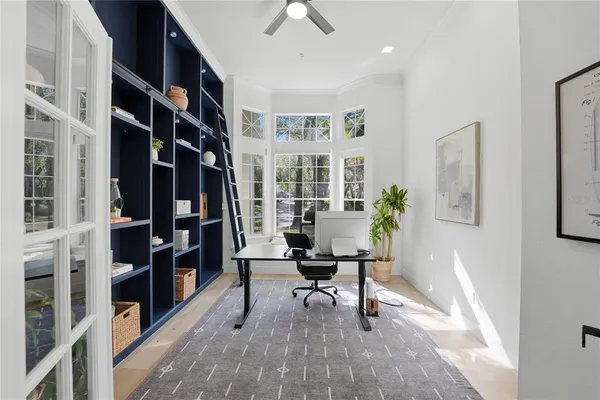 a workspace with furniture and a book shelf